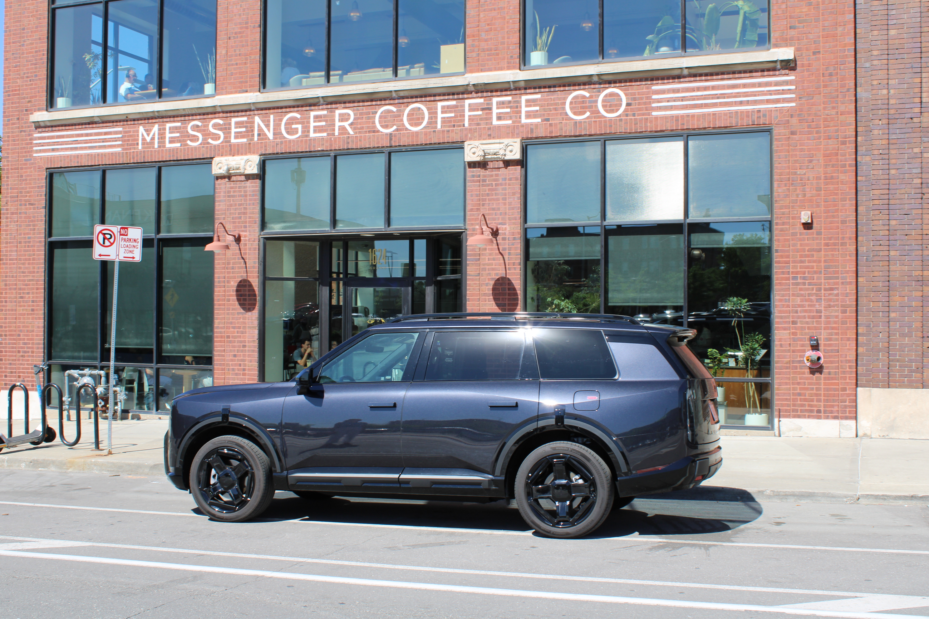 A 2027 Kia Telluride in front of Messenger Coffee in Kansas City, MO.